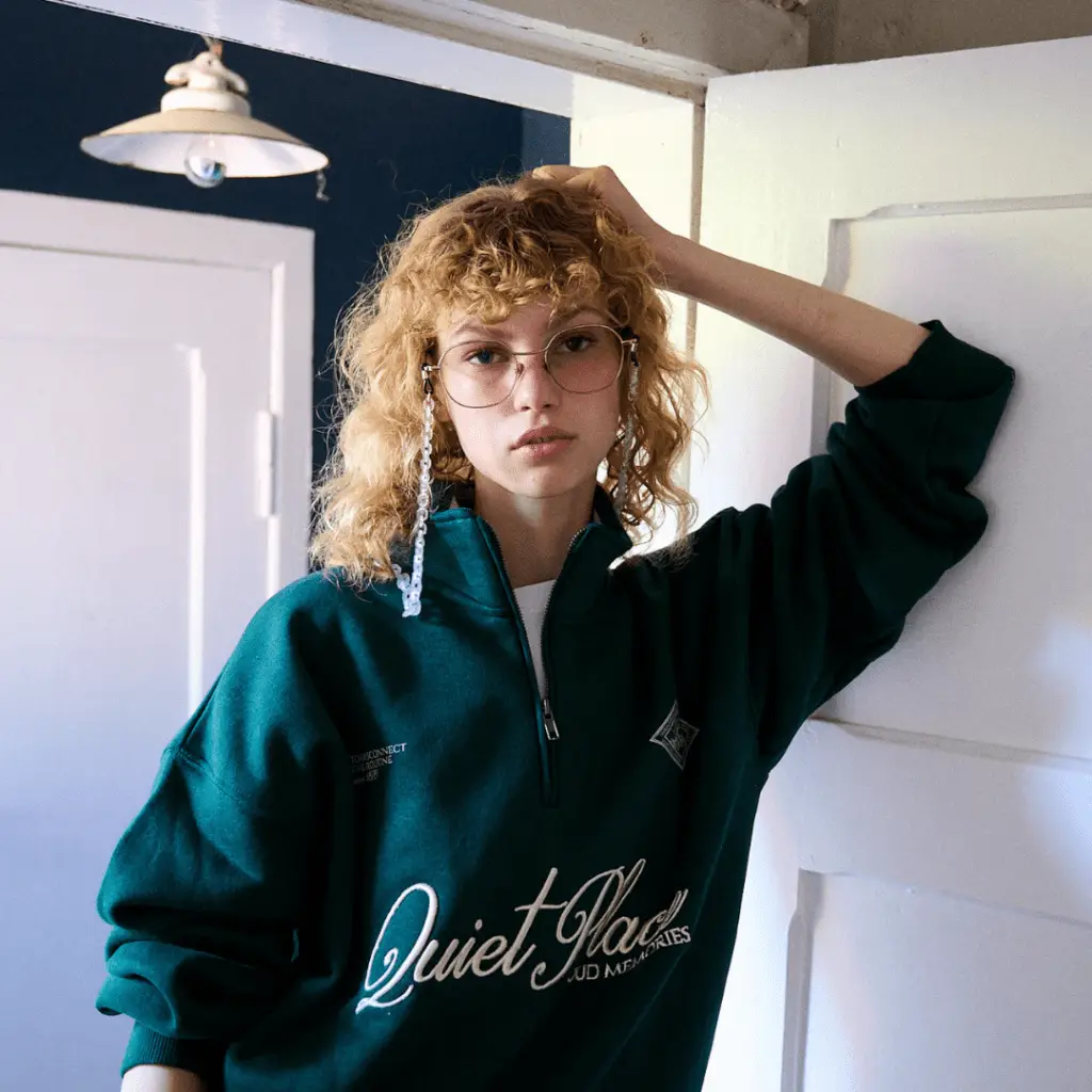 Frau in grünem Sweatshirt mit Coblens Brille.